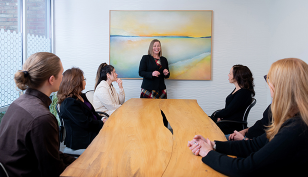 Melanie Harding, MRSC's executive director, leading a five-person group discussion in a conference room.