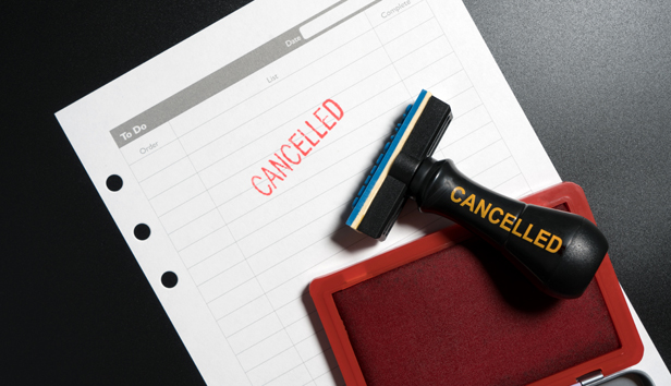 Red stamp labeled cancelled set against business to do list