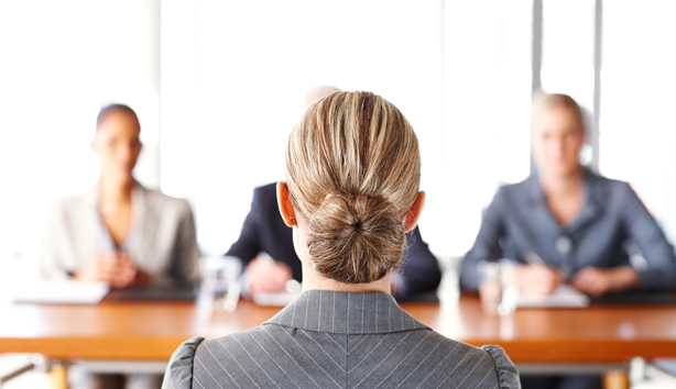 A women is interviewed by a panel