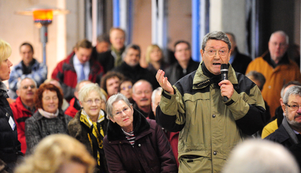 A person speaks at a public meeting