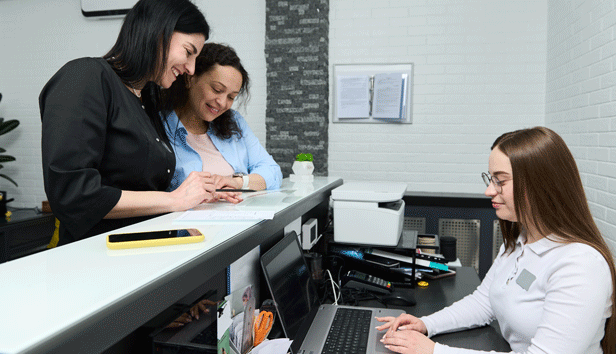 2 women apply for a permit at a counter