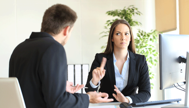Woman gesturing 'no' to her colleague