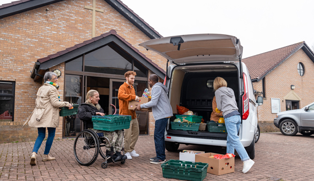 Volunteer drops off food at a church based food pantry