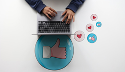 person on laptop using emojis