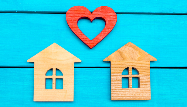 Wooden houses and heart on a blue background