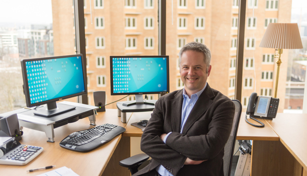 Oskar Rey seated at computer desk in MRSC's offices