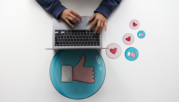 person on laptop using emojis